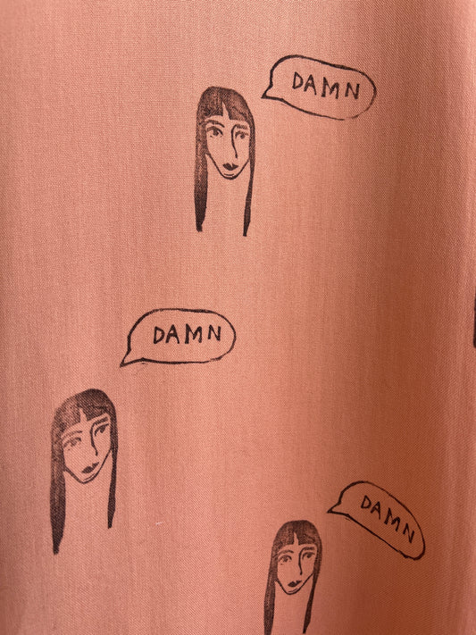Damn Girl Hand printed on a pastel salmon silk shirt