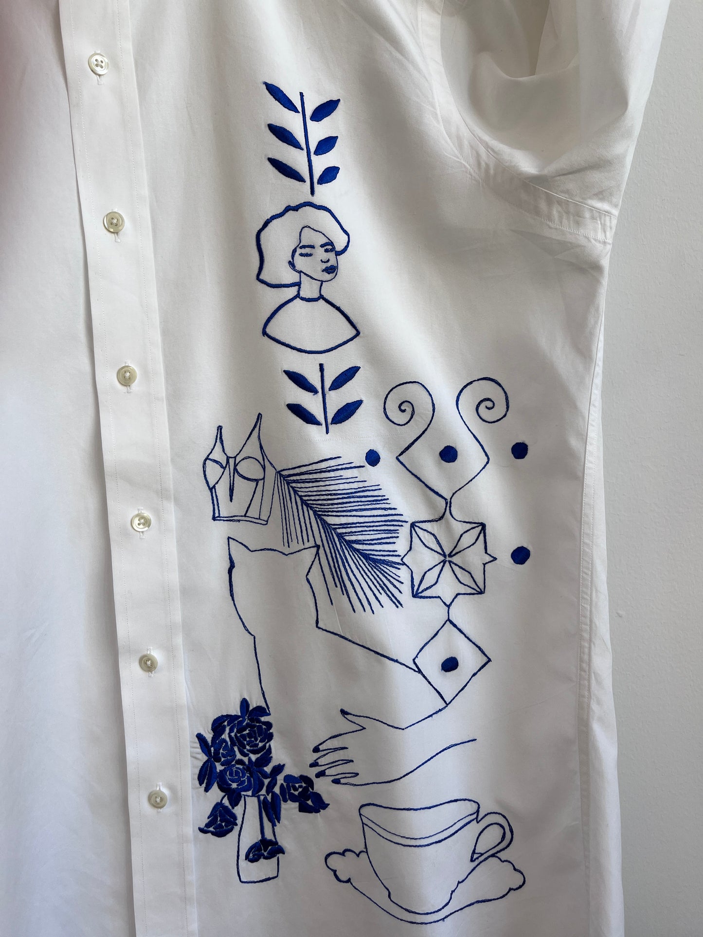 Her Universe in Blue embroidered on a white shirt