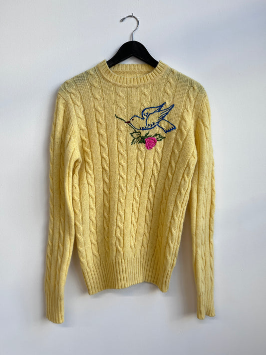 The rose bird on a yellow sweater