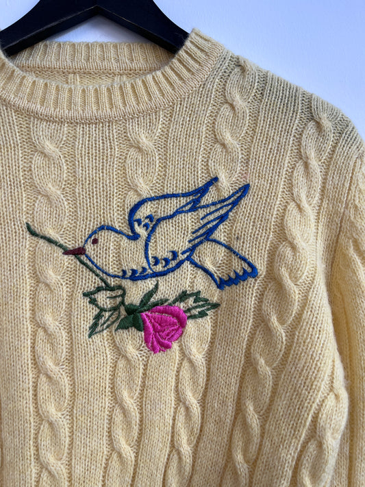 The rose bird on a yellow sweater