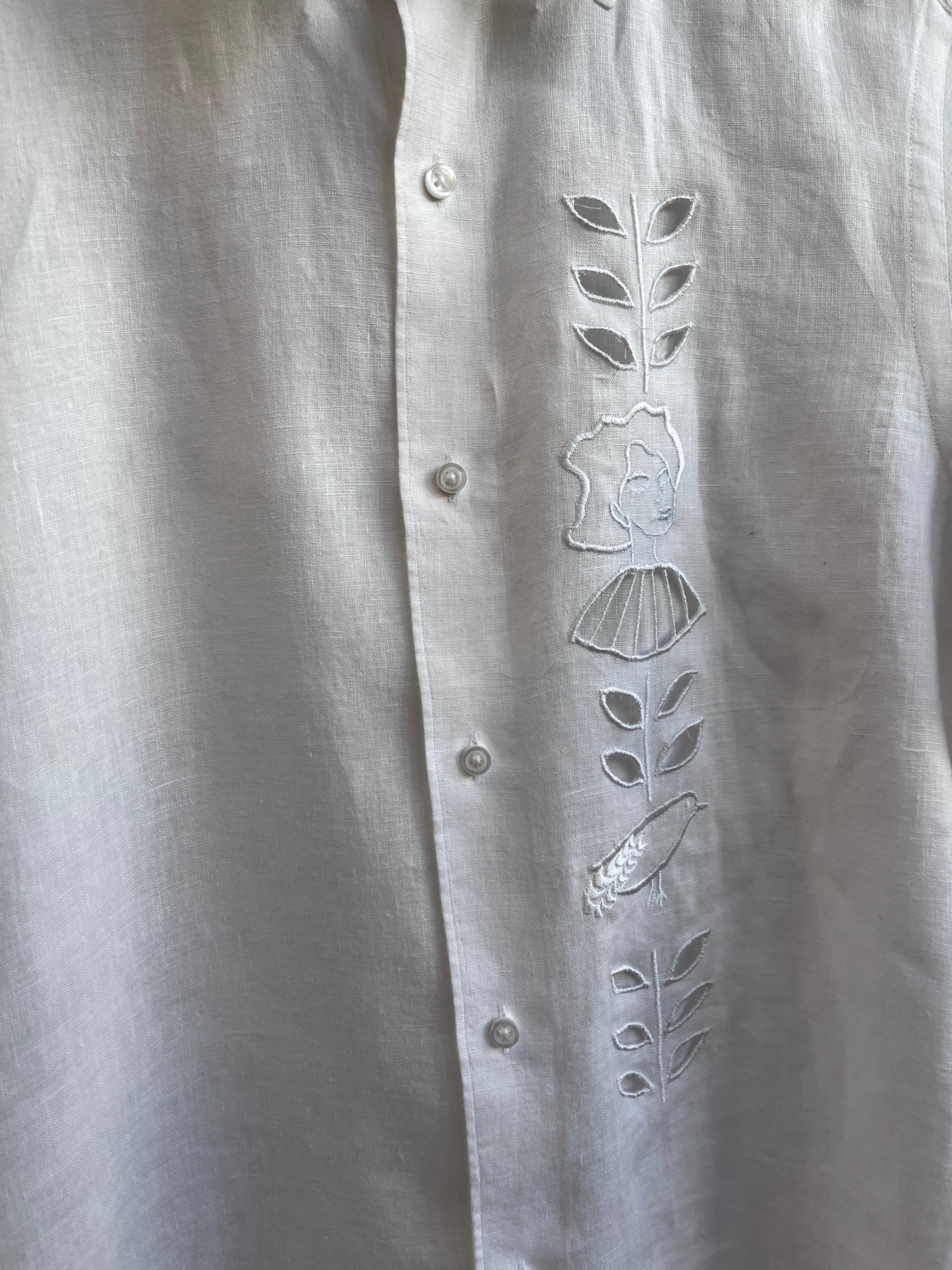 Cut work embroidery on a white linen shirt