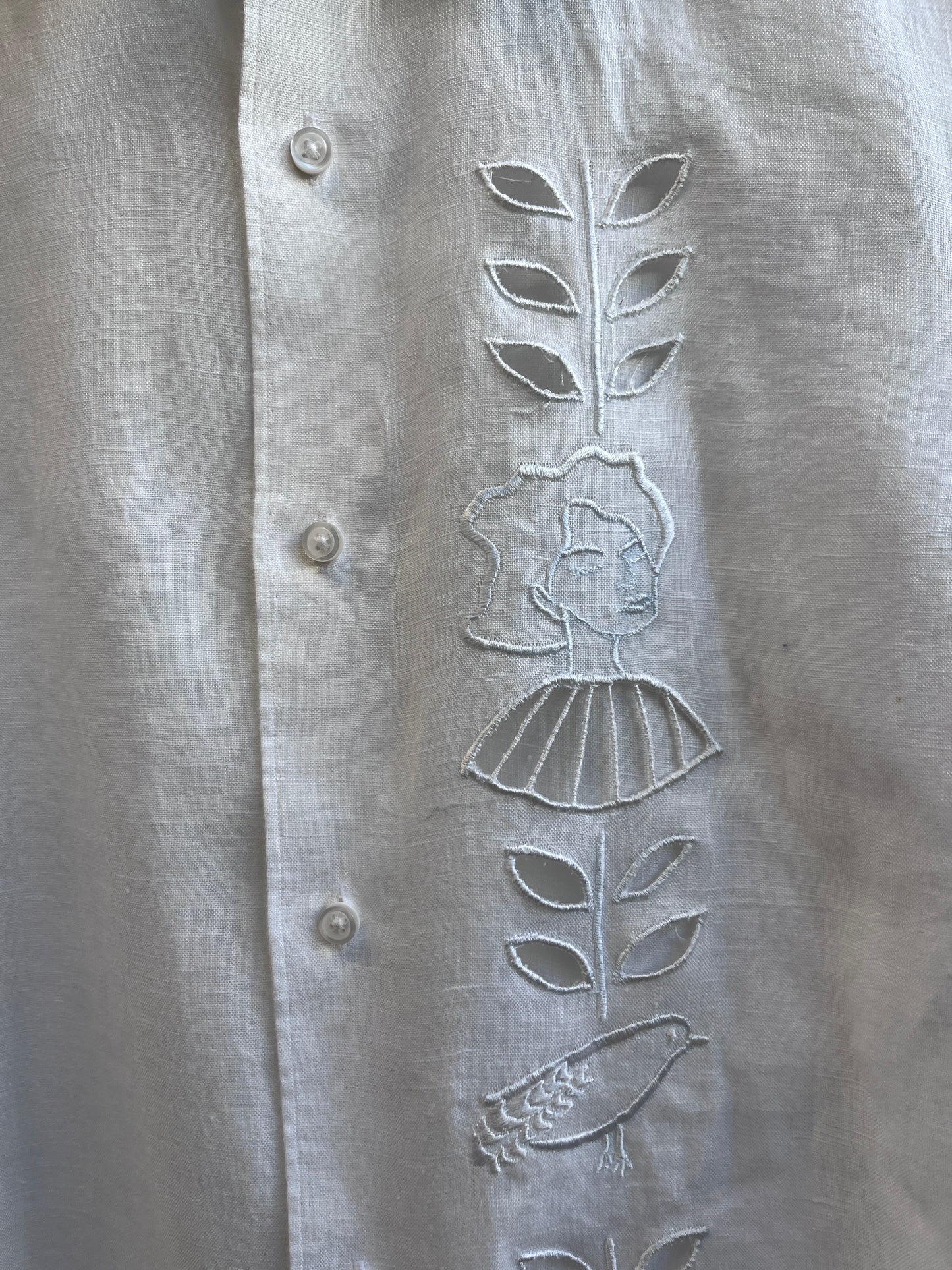 Cut work embroidery on a white linen shirt