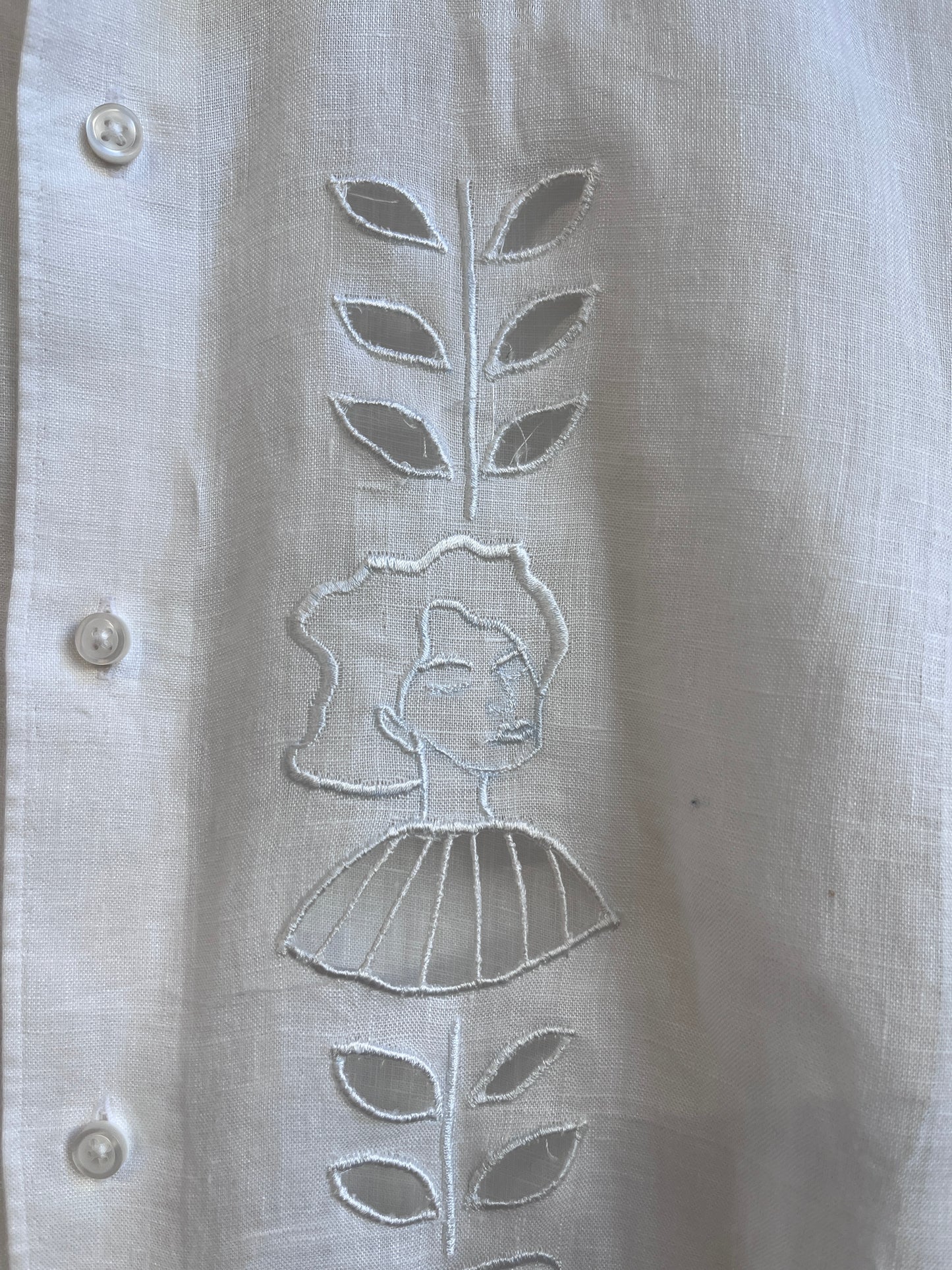 Cut work embroidery on a white linen shirt