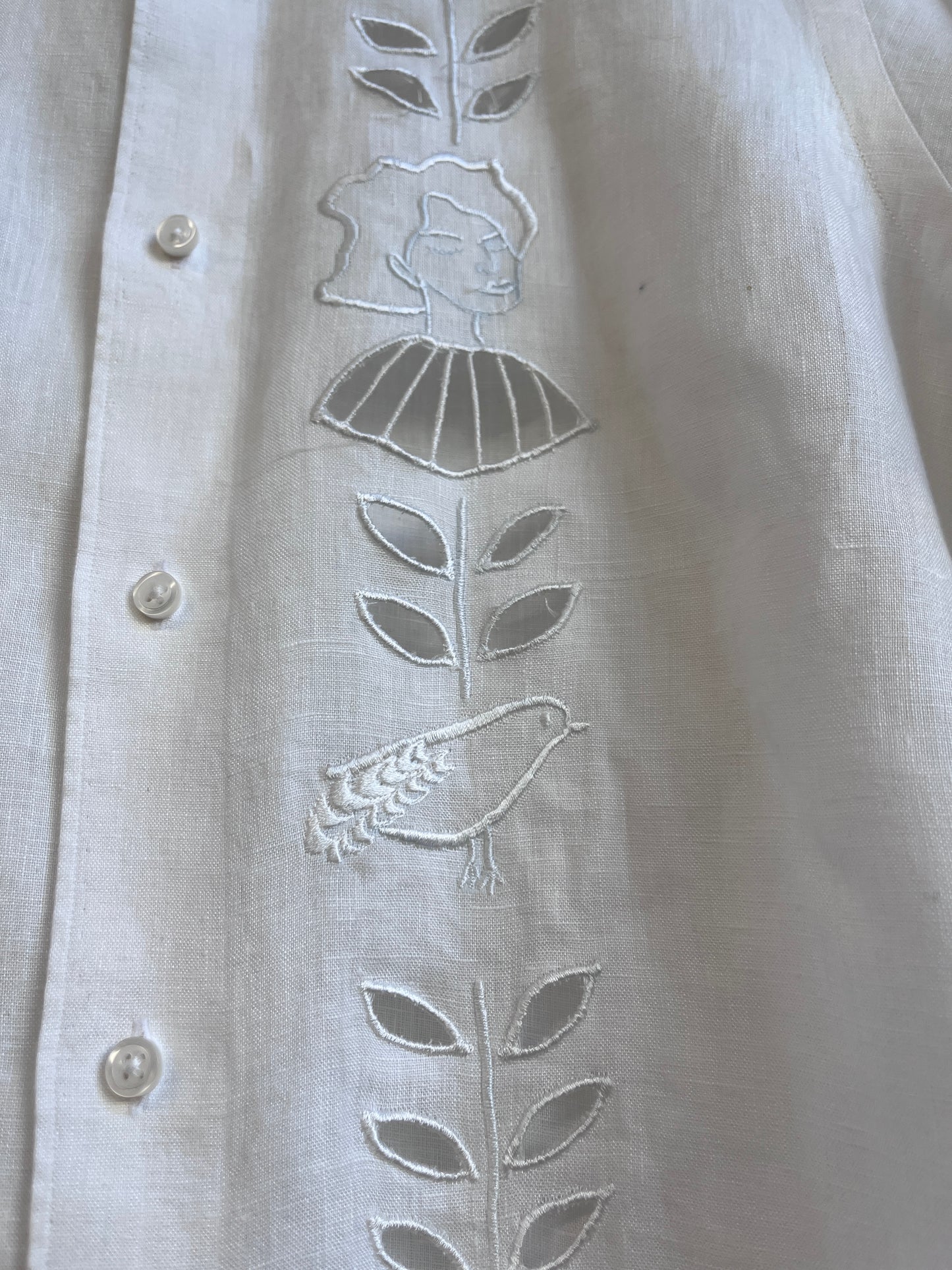 Cut work embroidery on a white linen shirt