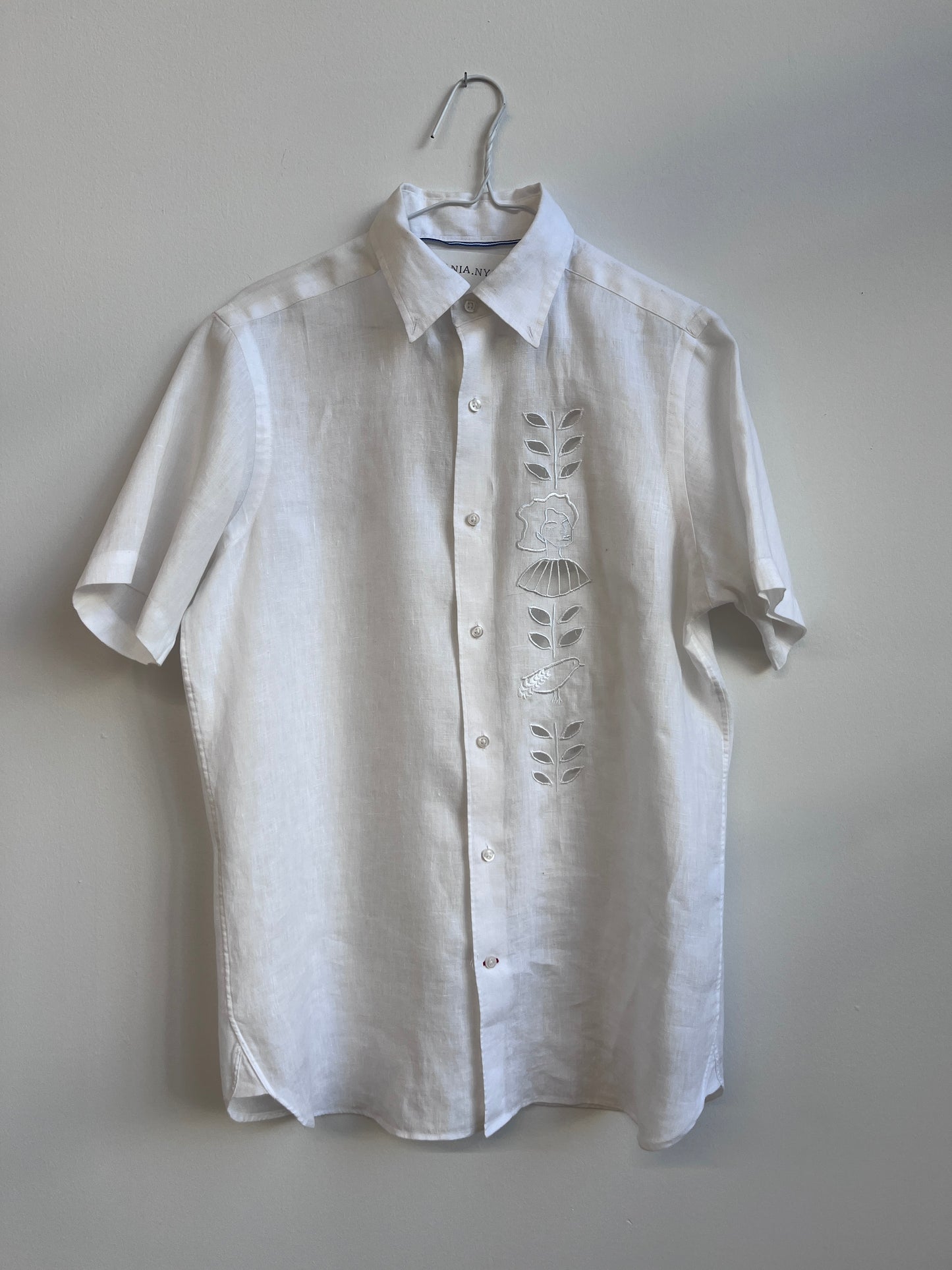 Cut work embroidery on a white linen shirt