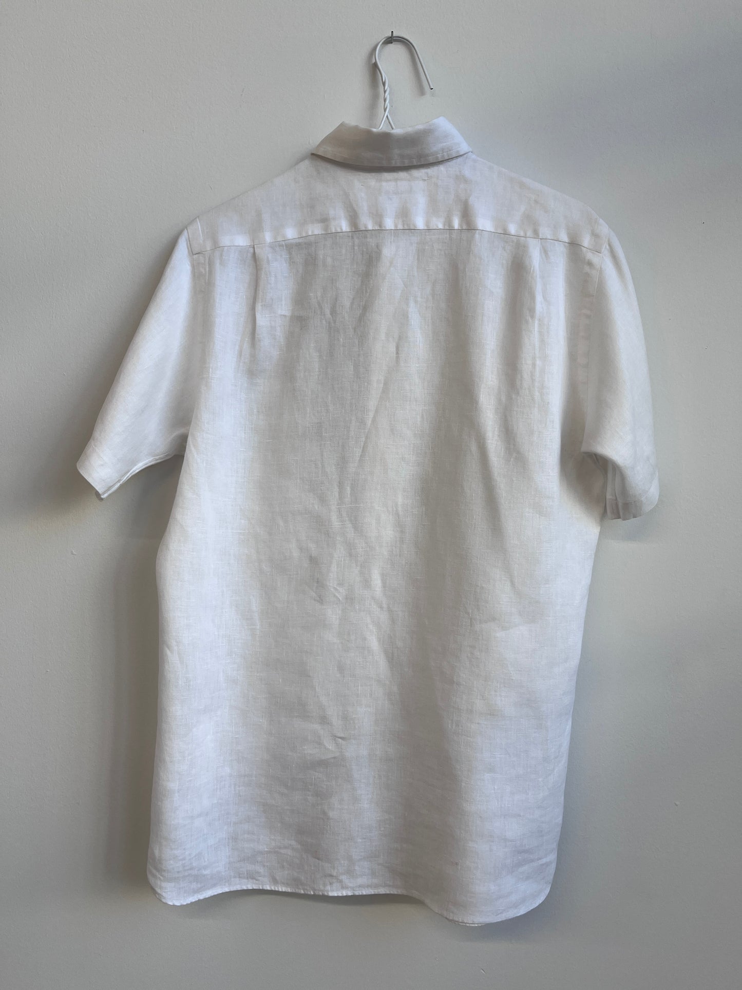 Cut work embroidery on a white linen shirt